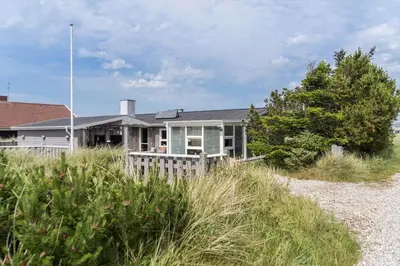 a house on the beach with grass in front of it at 514-Thisted-Fiskervej-53 in Thisted