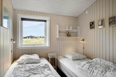 two beds in a room with a window at 514-Thisted-Fiskervej-53 in Thisted