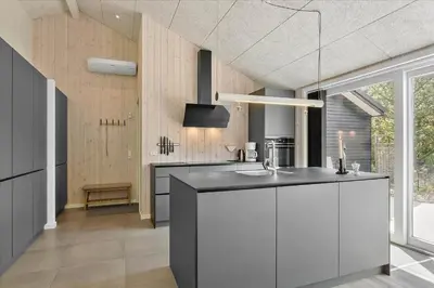 a kitchen with white cabinets and a black counter top at 171-Thisted-Molgaardsvej-71 in Thisted