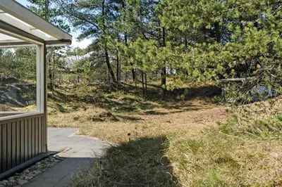 a porch of a house with trees and a sidewalk at 746-Thisted-Blamunkevej-36 in Thisted