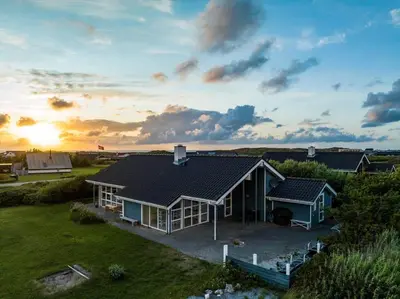 an aerial view of a house with the sun setting at 950-Thisted-Mombak-1 in Torsted