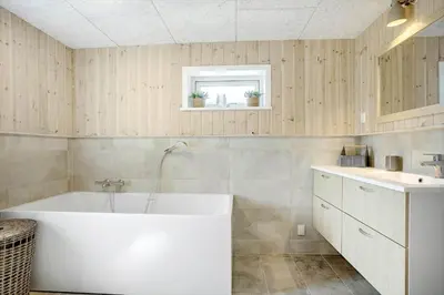 a bathroom with a white tub and a sink at 842-Thisted-Orredvej-40 in Thisted
