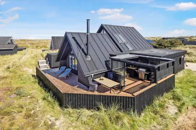 a house on a deck in the middle of a field at 842-Thisted-Orredvej-40 in Thisted