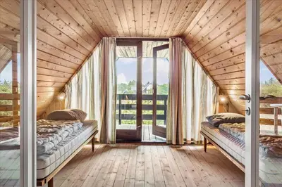 two beds in a room with a large window at 875-Thisted-Flyndervej-23 in Thisted