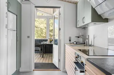 a kitchen with a door leading to a patio at 589-Thisted-Klitrosevej-3 in Thisted