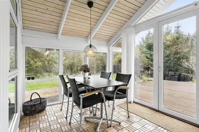 a dining room with a table and chairs at 435-Vestervig-Sivsangervej-32 in Vestervig