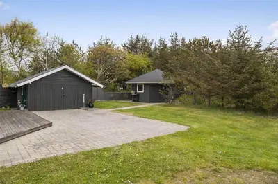 a house with a garage and a grass yard at 435-Vestervig-Sivsangervej-32 in Vestervig