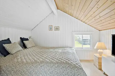 a white bedroom with a bed and a window at 571-Thisted-Tunvej-21 in Thisted