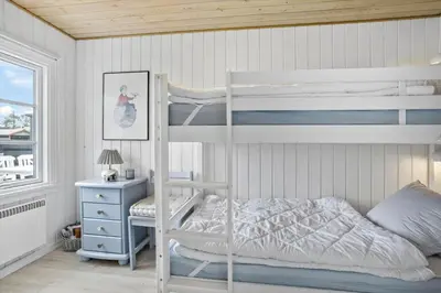 a bedroom with two bunk beds and a desk at 571-Thisted-Tunvej-21 in Thisted