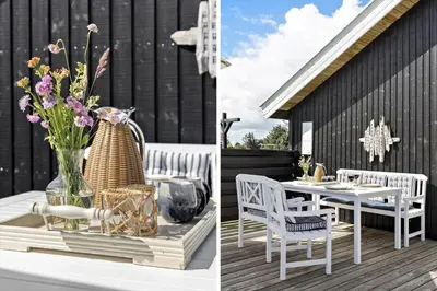 a patio with a table and chairs and a vase of flowers at 571-Thisted-Tunvej-21 in Thisted