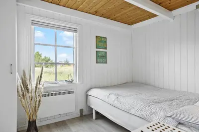 a white bedroom with a bed and a window at 571-Thisted-Tunvej-21 in Thisted