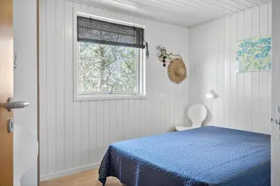 a bedroom with a blue bed and a window at 191-Thisted-Bredkaervej-61 in Thisted