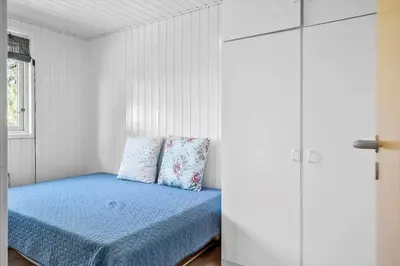 a bedroom with a bed with blue sheets and a window at 191-Thisted-Bredkaervej-61 in Thisted
