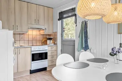 a kitchen with a white table and white appliances at 191-Thisted-Bredkaervej-61 in Thisted