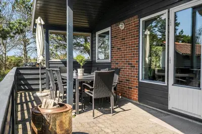 a patio with a table and chairs on a house at 191-Thisted-Bredkaervej-61 in Thisted