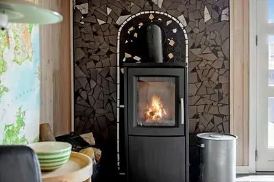 a wood stove with a fire in a room at 486-Thisted-Fiskervej-57 in Thisted