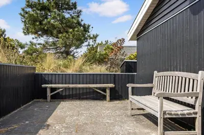 two wooden benches sitting next to a fence at 486-Thisted-Fiskervej-57 in Thisted