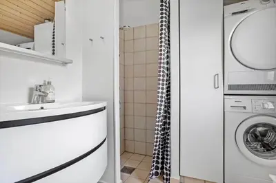 a bathroom with a sink and a washing machine at 486-Thisted-Fiskervej-57 in Thisted