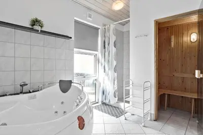 a large bathroom with a tub and a window at 404-Thisted-Klemsvej-16 in Thisted