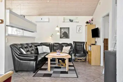 a living room with a leather couch and a table at 404-Thisted-Klemsvej-16 in Thisted