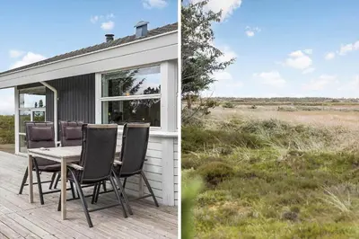 a house with a table and chairs on a deck at 248-Thisted-Molgaardsvej-28 in Thisted