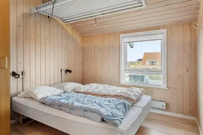 a bedroom with a bed in a room with a window at 123-Thisted-Orredvej-30 in Thisted