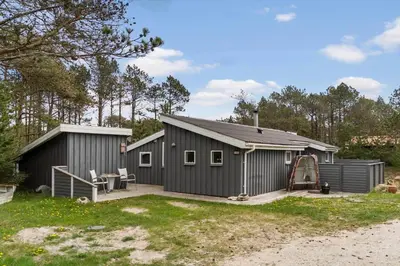 a gray building with a patio and a playground at 1321-Thisted-Blamunkevej-58 in Thisted