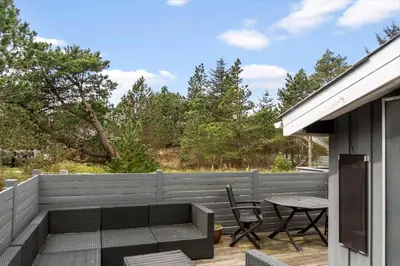 a patio with a table and chairs and a fence at 1321-Thisted-Blamunkevej-58 in Thisted