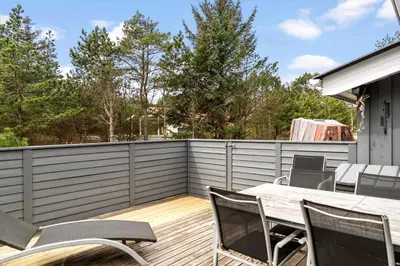 a patio with a table and chairs on a fence at 1321-Thisted-Blamunkevej-58 in Thisted