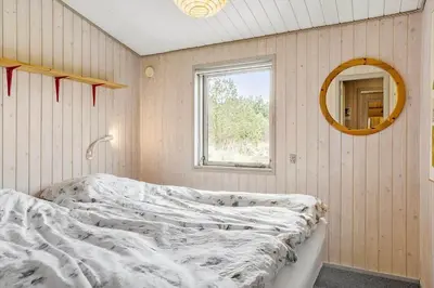 a bedroom with two beds and a mirror at 849-Thisted-Havtornvej-6 in Thisted