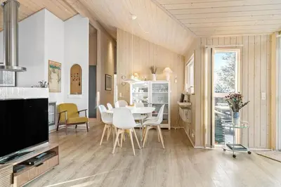 a dining room with a table and chairs and a television at 170-Thisted-Sotungevej-2 in Thisted
