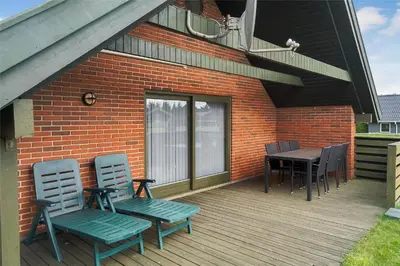 a deck with chairs and a table and a balcony at 400-Thisted-Nordsovej-186 in Thisted