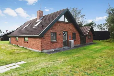a brick house with a black roof on a yard at 400-Thisted-Nordsovej-186 in Thisted