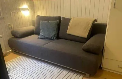 a couch with two pillows on it in a room at 269-Vestervig-Blishonevej-19 in Vestervig