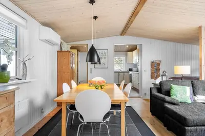 a dining room with a table and a couch at 286-Thisted-Blamunkevej-49 in Thisted