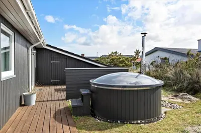 a hot tub sitting on a deck next to a house at 497-Thisted-Nordsovej-26 in Thisted