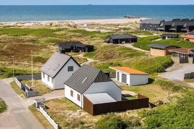 a group of houses on a hill next to the ocean at 1313-Thisted-Hotelvej-4 in Thisted