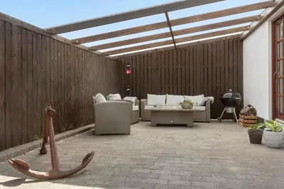 a patio with couches and chairs and a roof at 1313-Thisted-Hotelvej-4 in Thisted