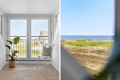 a room with a chair and a view of the ocean at 1313-Thisted-Hotelvej-4 in Thisted