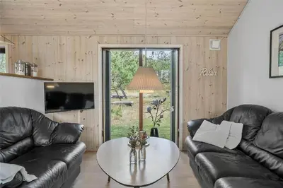 a living room with two leather couches and a table at 748-Thisted-Blamunkevej-65 in Thisted