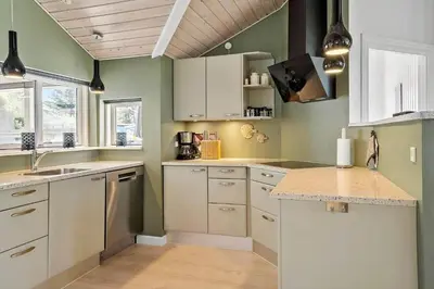 a kitchen with green walls and white cabinets at 878-Thisted-Smedevej-15 in Thisted