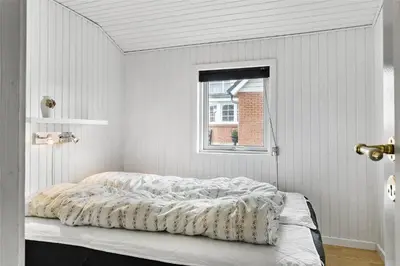 a bed in a white room with a window at 505-Thisted-Fiskervej-50-A in Thisted