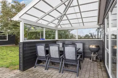 a pergola on a patio with chairs and a grill at 505-Thisted-Fiskervej-50-A in Thisted