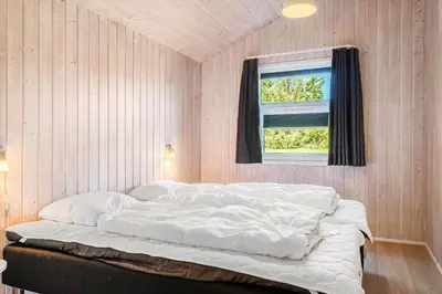 a white bed in a room with a window at 233-Thisted-Tunvej-5 in Thisted