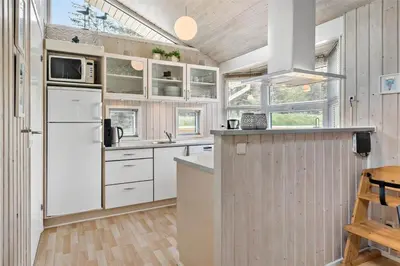 a kitchen with white cabinets and a white refrigerator at 233-Thisted-Tunvej-5 in Thisted