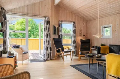 a living room with wood paneling and a table and chairs at 233-Thisted-Tunvej-5 in Thisted