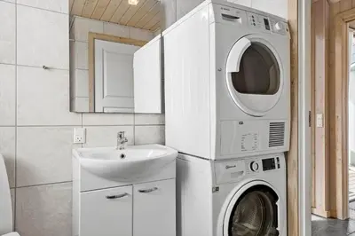 a washing machine and a sink in a bathroom at 262-Vestervig-Magevej-15 in Vestervig