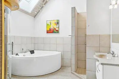 a white bathroom with a tub and a sink at 262-Vestervig-Magevej-15 in Vestervig
