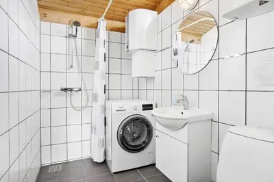 a white bathroom with a washing machine and a sink at 806-Thisted-Nordsovej-39 in Thisted