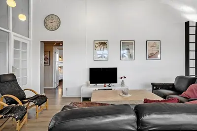 a living room with a couch and a tv at 941-Thisted-Klitstien-37 in Torsted